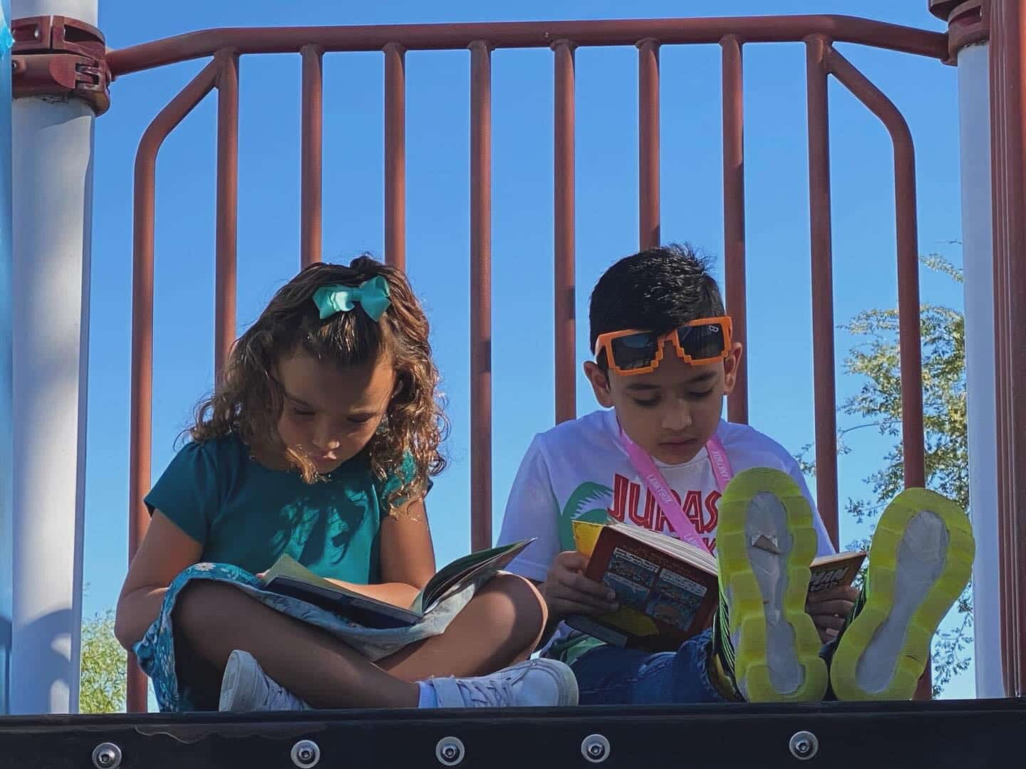 Two students reading a book together
